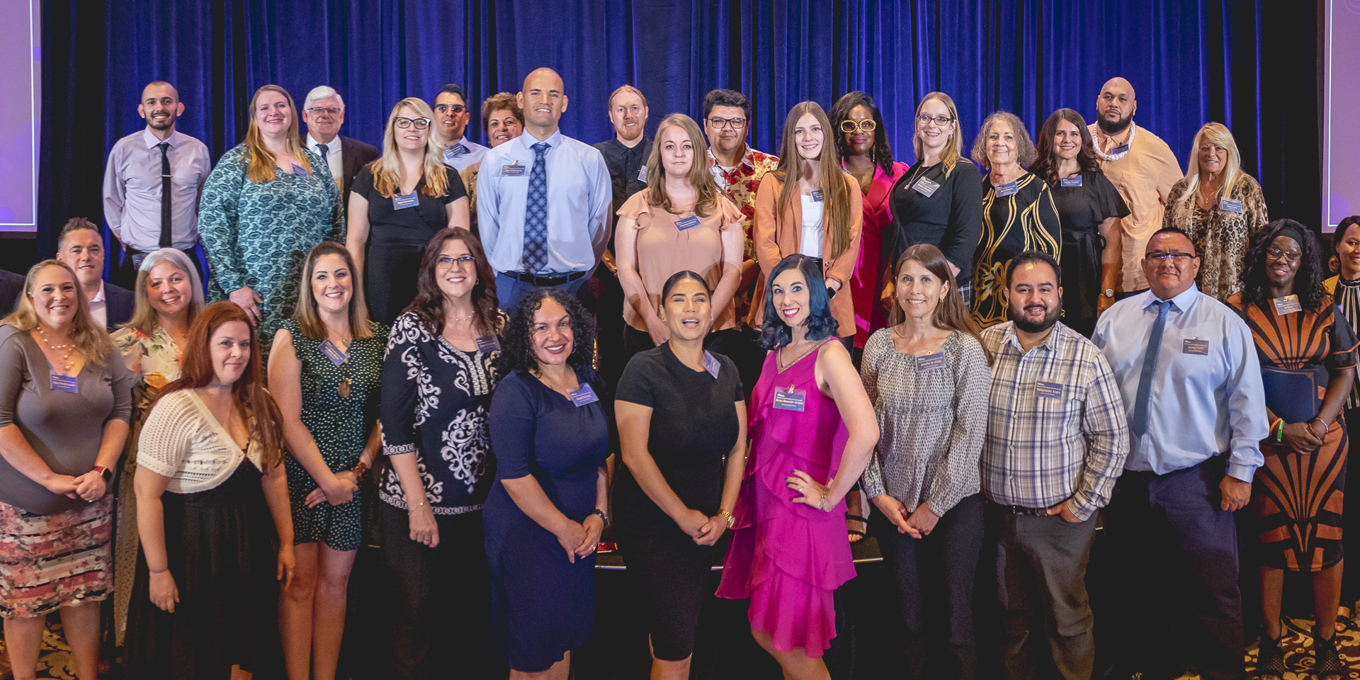 Jeff Meshey standing with 30 of the former Adult Learner scholarship recipients. 