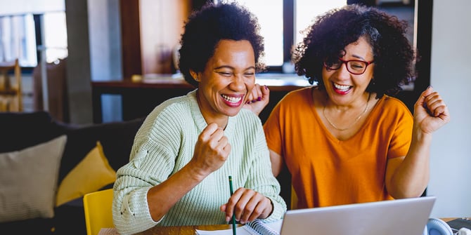 Two excited ladies on the Desert Financial website learning how to grow their savings.