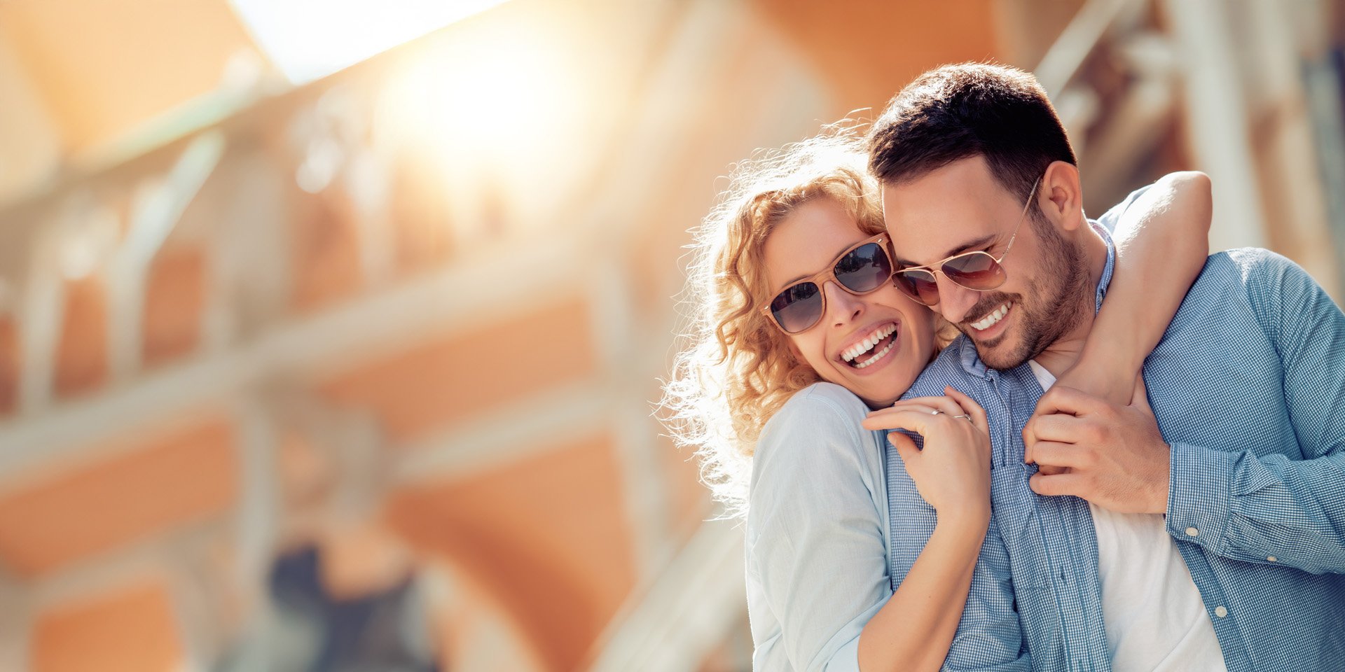 A man and woman hugging and laughing