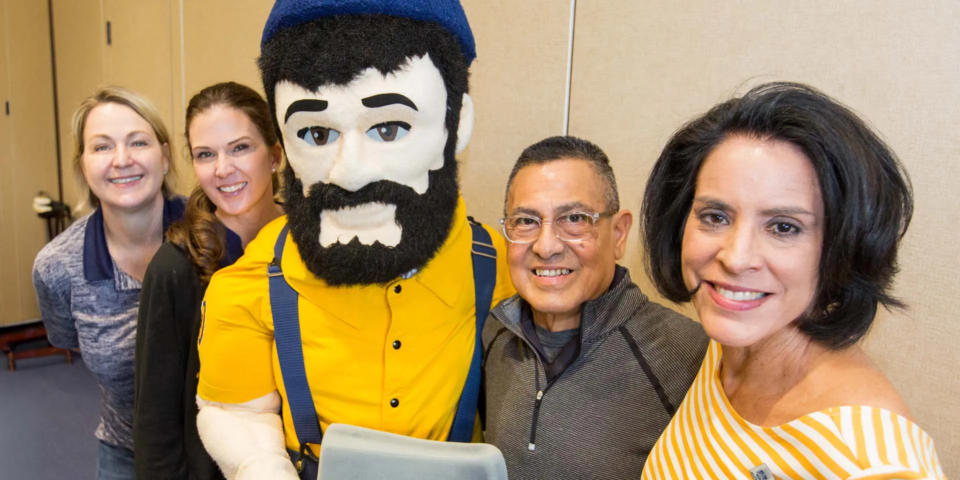 NAU fans at a game, cheering on the Lumberjacks